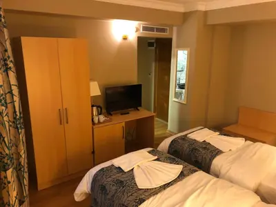 a hotel room with two beds and a television at Artika Hotel in Istanbul