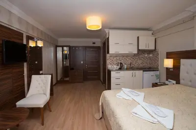 a kitchen and a bedroom with a bed and a table at City House in Istanbul