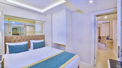 a bedroom with a bed with blue and white pillows at Beethoven Premium Hotel in Istanbul