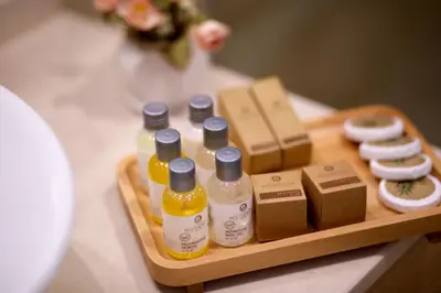 a wooden tray with bottles of cosmetics on a table at Beethoven Premium Hotel in Istanbul