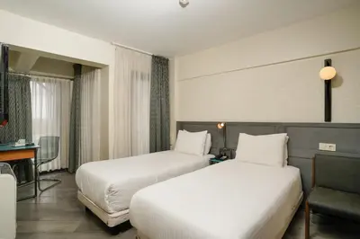 a hotel room with two beds and a desk at Faros Hotel Taksim-Special Category in Istanbul