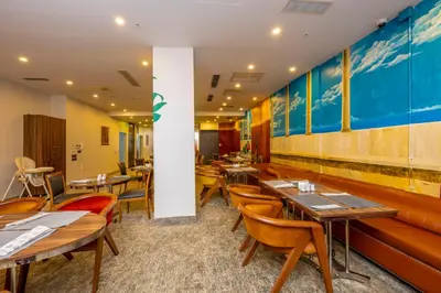 a restaurant with wooden tables and chairs and blue walls at Premist Hotels Taksim in Istanbul