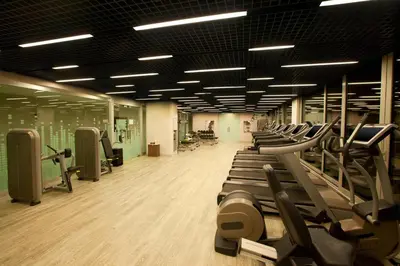a gym with a row of treadmills and machines at Le Meridien Istanbul Etiler in Istanbul