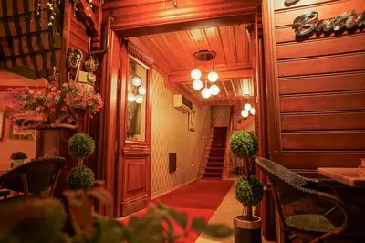 a hallway of a restaurant with a table and chairs at Eskibağ Butik Hotel in Buyukada