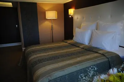 a hotel room with a large bed with white pillows at Paradise Island Hotel in Gebze