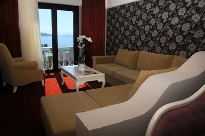 a living room with a couch and a table at Paradise Island Hotel in Gebze