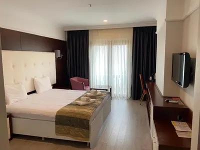 a hotel room with a large bed and a television at Paradise Island Hotel in Gebze