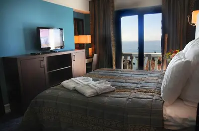 a hotel room with a bed with a flat screen tv at Paradise Island Hotel in Gebze