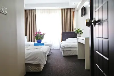 a hotel room with two beds and a window at holiday family apart in Istanbul