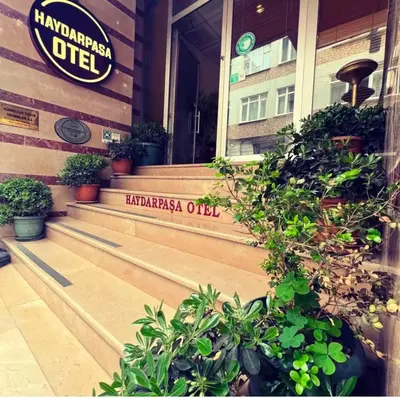 a sign on the front of a building with plants at Haydarpasa Hotel in Istanbul