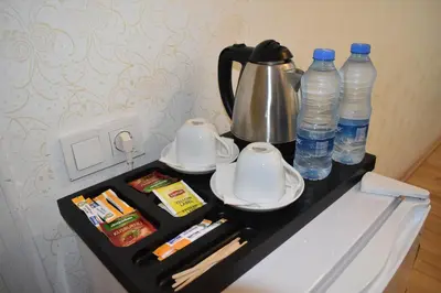 a table with a tea kettle and bottles of water at Paris Garden Hotel Istanbul in Istanbul