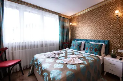 a bedroom with a bed with a dress on it at Paris Garden Hotel Istanbul in Istanbul