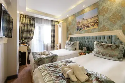 a hotel room with two beds and a window at Sirkeci Ersu Hotel & SPA in Istanbul