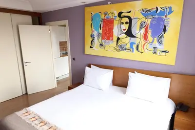 a bedroom with a bed and a painting on the wall at Taba Luxury Suites and Hotel in Istanbul