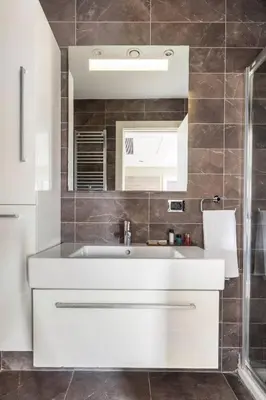 a bathroom with a white sink and a mirror at Taba Luxury Suites and Hotel in Istanbul