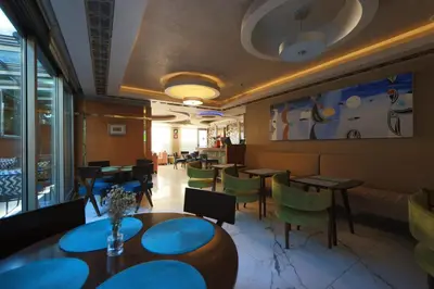 a restaurant with tables and chairs in a room at Taba Luxury Suites and Hotel in Istanbul