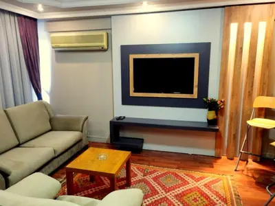 a living room with a couch and a flat screen tv at Hotel Anibal in Gebze