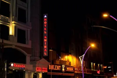 a building with a neon sign on it at night at Hotel Anibal in Gebze