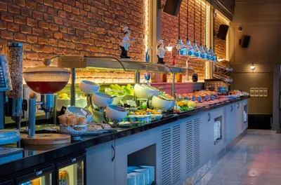 a buffet line with bowls and dishes on it at Port Bosphorus Hotel in Istanbul