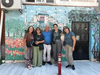 a group of people standing in front of a mural at Happy Suite Boutique Hotel in Istanbul