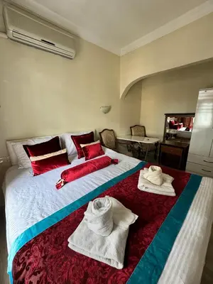 a bedroom with a large bed with towels on it at Happy Suite Boutique Hotel in Istanbul