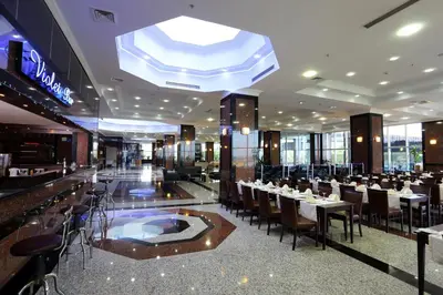 a restaurant with tables and chairs in a building at Eser Diamond Hotel Spa & Convention Center İstanbul in Silivri