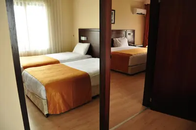 a hotel room with two beds and a mirror at Eser Diamond Hotel Spa & Convention Center İstanbul in Silivri