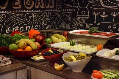 a buffet line with bowls of fruits and vegetables at Hotel Ephesus Istanbul in Istanbul