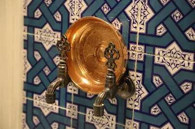 a gold clock on a blue and white wall at Alfa Suites & SPA in Sapanca