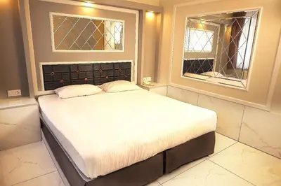 a bed in a room with two windows at Bakirkoy Tashan Business & Airport Hotel in Istanbul