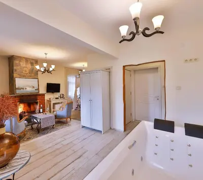 a large bathroom with a tub and a living room at Park Mandalin Hotel - Adult only in Agva