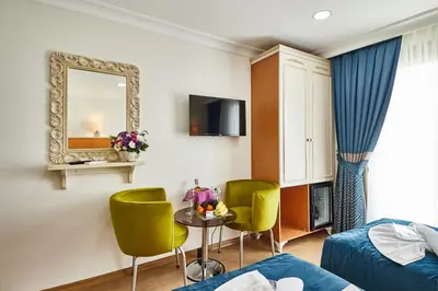 a hotel room with a bed and a table and chairs at Kumru Hotel in Istanbul