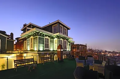 a house on a balcony with tables and chairs at HHK Hotel in Istanbul