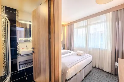a bedroom with a bed and a bathroom with a tub at Best House Hotel OLD TOWN in Istanbul
