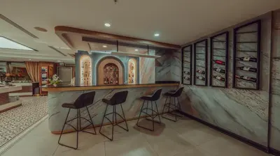 a kitchen with a bar with stools in a room at Grand Makel Hotel Topkapi in Istanbul