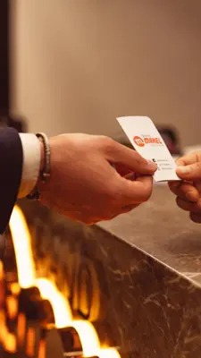 a person holding a card in front of a fire at Grand Makel Hotel Topkapi in Istanbul