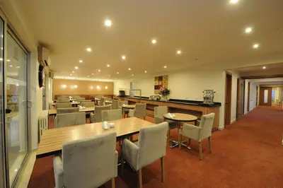 a dining room with a table and chairs at Kardes Hotel in Bursa