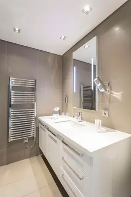a bathroom with a white sink and a mirror at Radisson Residences Avrupa TEM Istanbul in Istanbul