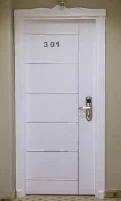 a white garage door with the number on it at Ceylan Hotel in Bursa