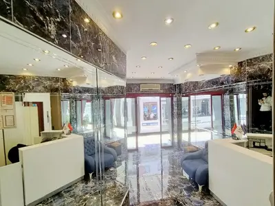 a lobby of a building with glass walls at Ceylan Hotel in Bursa