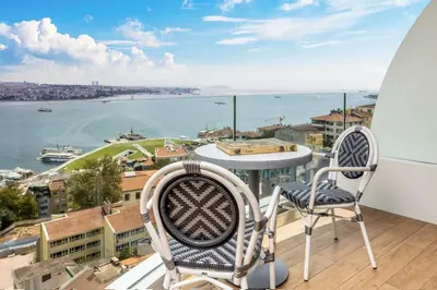 two chairs on a balcony with a view of the water at Opera Hotel Bosphorus - Preferred Hotels and Resorts in Istanbul
