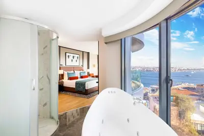 a bedroom with a bed and a view of the water at Opera Hotel Bosphorus - Preferred Hotels and Resorts in Istanbul