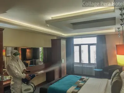 a person in a room with a bed at Collage Pera Hotel in Istanbul