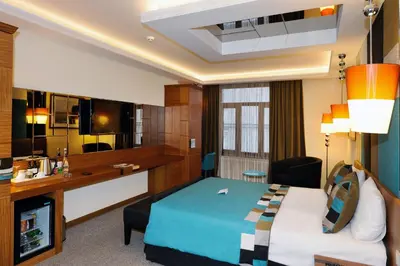 a hotel room with a bed and a desk at Collage Pera Hotel in Istanbul