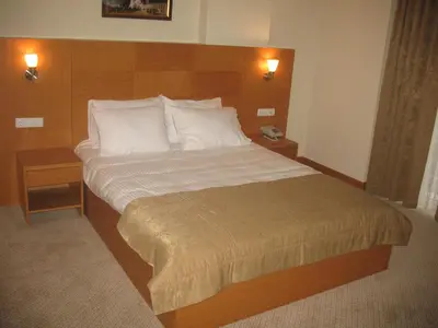 a bedroom with a large bed with white pillows at Shilla Hotel in Velimeşe