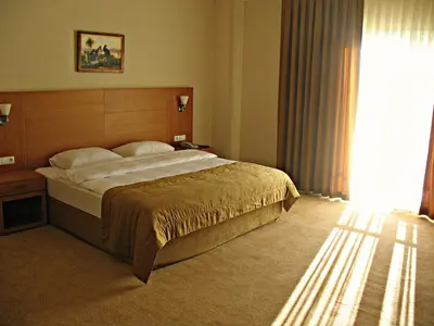 a bedroom with a bed and a large window at Shilla Hotel in Velimeşe