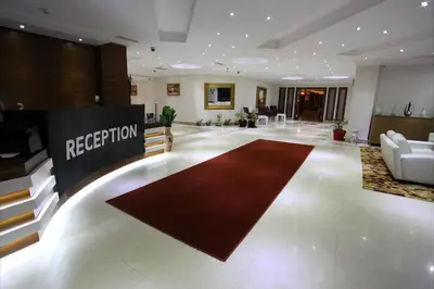 a lobby with a red rug in the middle of a room at Shilla Hotel in Velimeşe