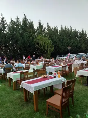 a group of tables and chairs in the grass at Shilla Hotel in Velimeşe