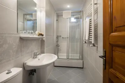 a white bathroom with a sink and a shower at Hotel Sari Konak in Istanbul