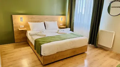 a bedroom with a large bed with a wooden headboard at Sultan Hostel & Guesthouse in Istanbul